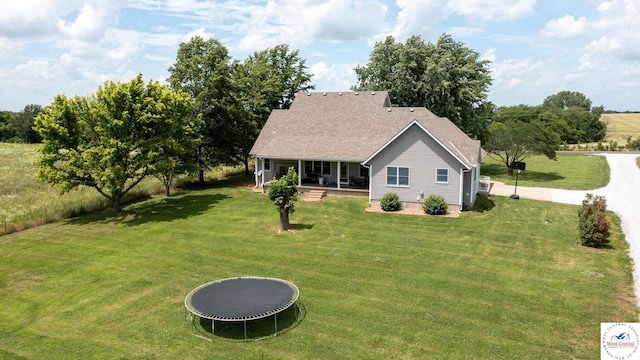 1766 NW M Hwy, Clinton, MO 64735 - view of front facade with a porch, a front lawn, a trampoline, and roof with shingles