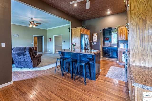1766 NW M Hwy, Clinton, MO 64735 - kitchen featuring ceiling fan, stainless steel fridge, light wood finished floors, a breakfast bar, and recessed lighting