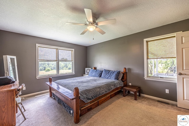 1766 NW M Hwy, Clinton, MO 64735 - bedroom featuring light colored carpet, a textured ceiling, and ceiling fan