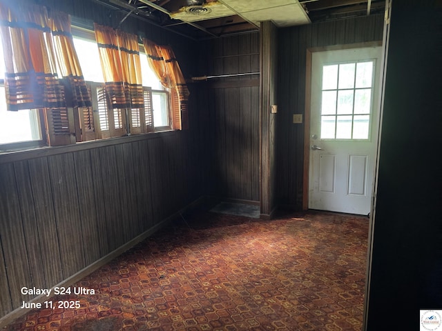 107 W 6th St, Urich, MO 64788 - carpeted empty room with wood walls