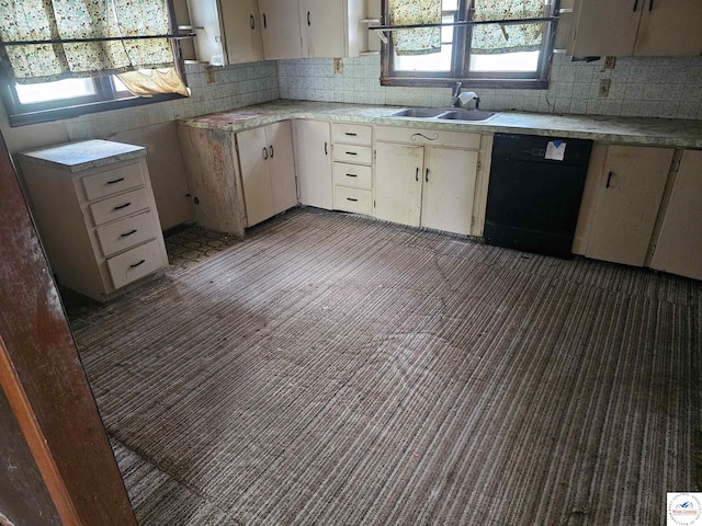 107 W 6th St, Urich, MO 64788 - kitchen with black dishwasher, light countertops, backsplash, and plenty of natural light