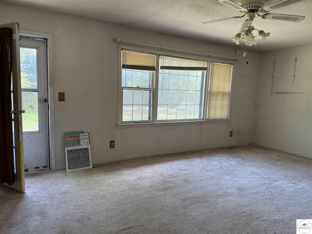 210 Salem Ave, Knob Noster, MO 65336 - unfurnished living room featuring carpet floors, ceiling fan, and a textured ceiling