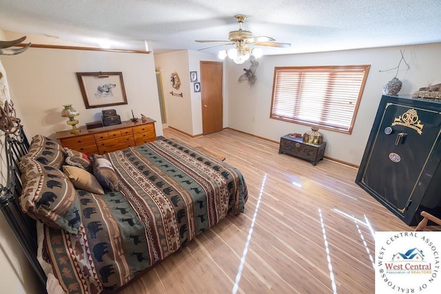662 W 6th St, Schell City, MO 64783 - bedroom with light wood-style flooring, ceiling fan, a textured ceiling, and baseboards