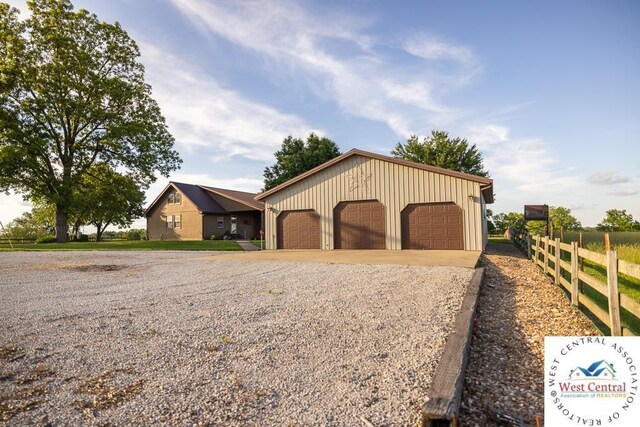 662 W 6th St, Schell City, MO 64783 - view of front of house with board and batten siding and a detached garage
