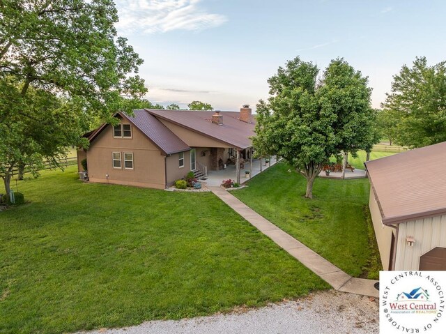 662 W 6th St, Schell City, MO 64783 - view of front facade featuring a front lawn and a chimney