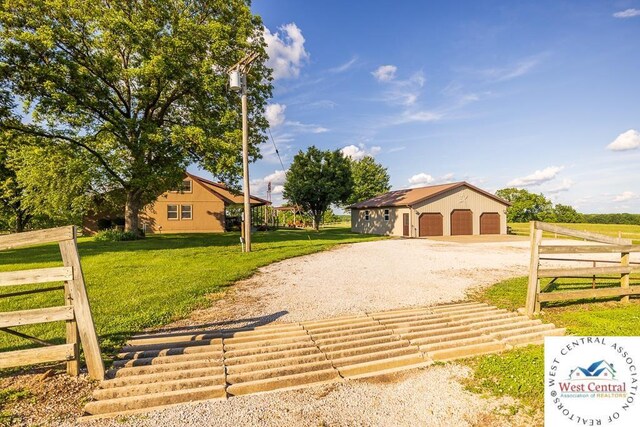 662 W 6th St, Schell City, MO 64783 - view of front of home featuring driveway, an outbuilding, and a garage