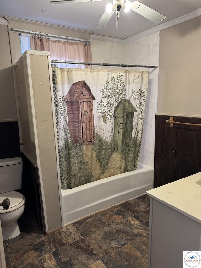 bathroom featuring shower / bath combo, vanity, stone finish flooring, toilet, and a ceiling fan