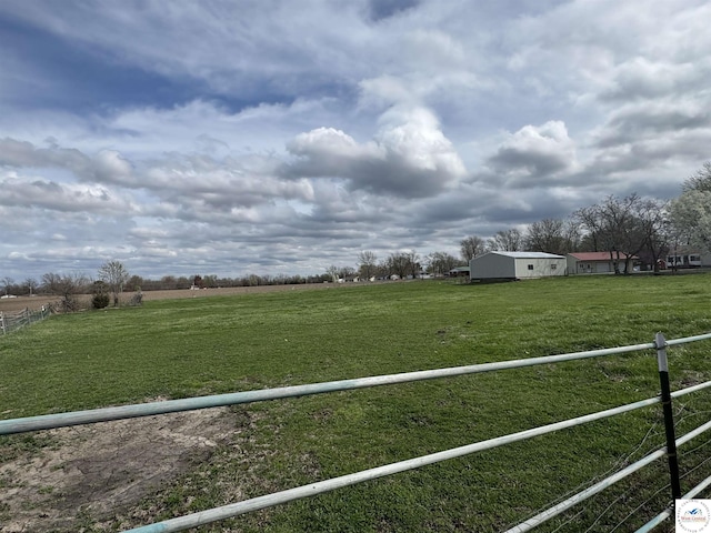 view of yard featuring fence and a rural view