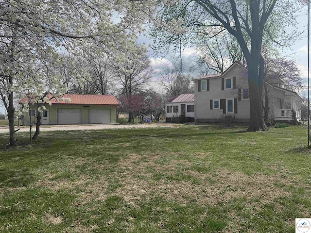 view of yard with an outdoor structure and an attached garage