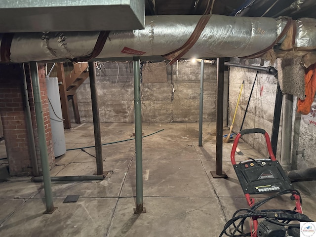 unfinished below grade area featuring water heater