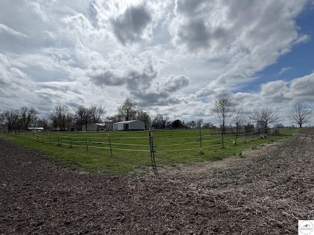 view of yard featuring a rural view and fence