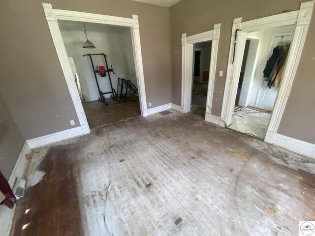 511 E Green St, Clinton, MO 64735 - unfurnished bedroom with hardwood / wood-style flooring and a closet