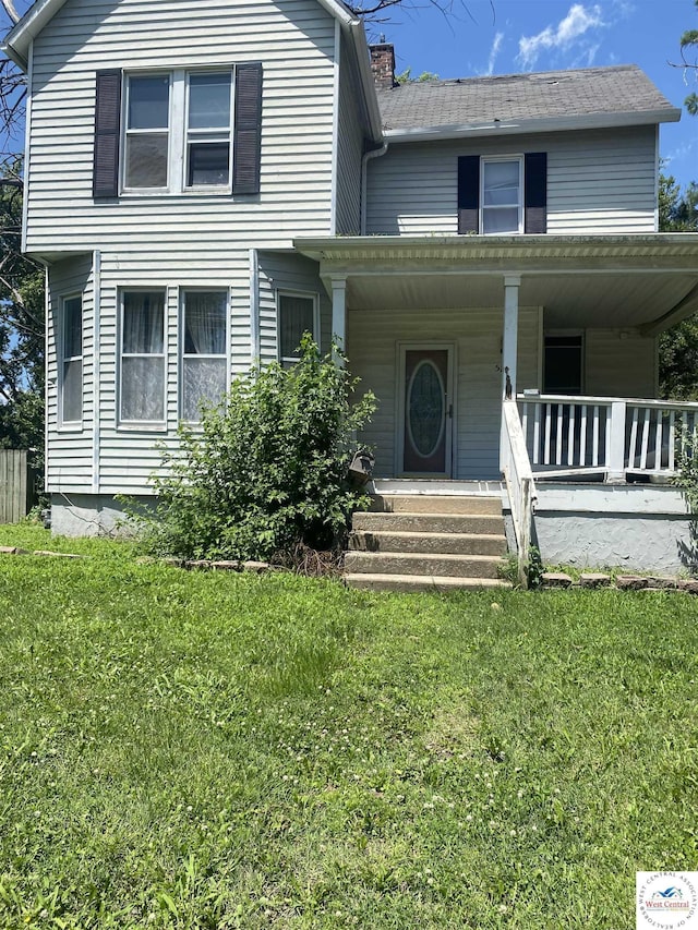 511 E Green St, Clinton, MO 64735 - view of front of house featuring a porch, a front yard, and a chimney