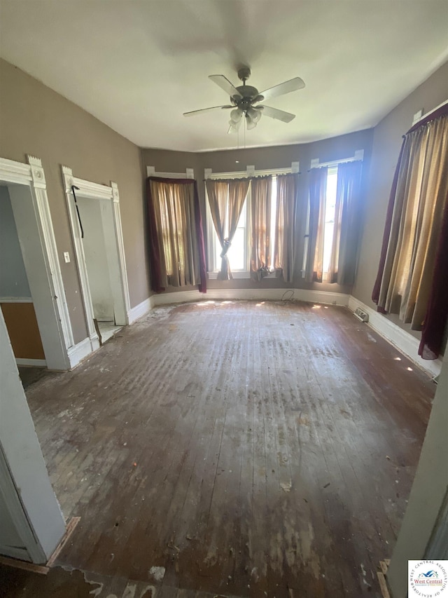 511 E Green St, Clinton, MO 64735 - unfurnished living room with wood-type flooring and ceiling fan
