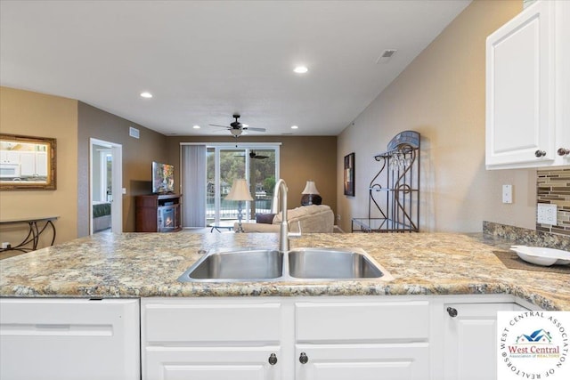 748 Pershing Dr, Camdenton, MO 65020 - kitchen with a ceiling fan, a sink, white cabinets, and light stone counters