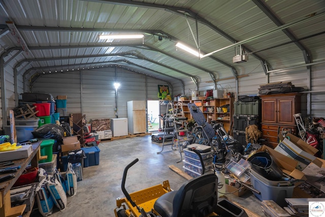 416 W Osage St, Warsaw, MO 65355 - garage with metal wall, freestanding refrigerator, and a garage door opener