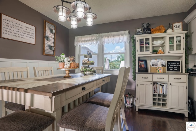416 W Osage St, Warsaw, MO 65355 - dining area with a chandelier, dark wood-type flooring, and a textured ceiling