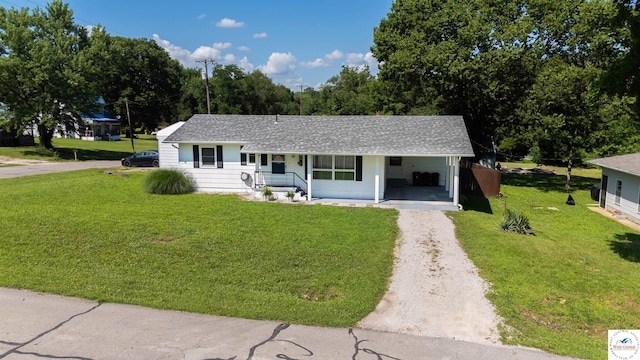 416 W Osage St, Warsaw, MO 65355 - view of front of home with driveway, a shingled roof, a front yard, covered porch, and an attached carport