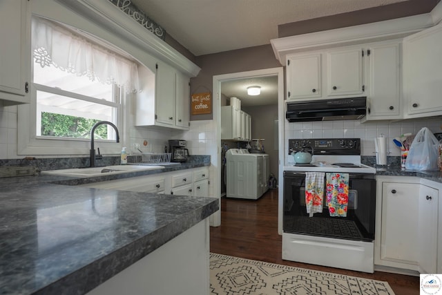 416 W Osage St, Warsaw, MO 65355 - kitchen with electric stove, under cabinet range hood, washer / dryer, dark countertops, and decorative backsplash