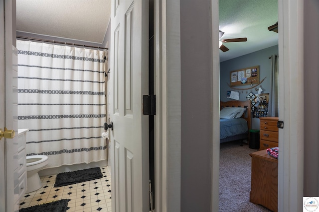 416 W Osage St, Warsaw, MO 65355 - bathroom with a textured ceiling, ceiling fan, a shower with shower curtain, ensuite bath, and tile patterned floors