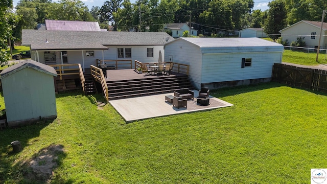 416 W Osage St, Warsaw, MO 65355 - rear view of property featuring a storage unit, a deck, a fenced backyard, outdoor dining space, and a patio area