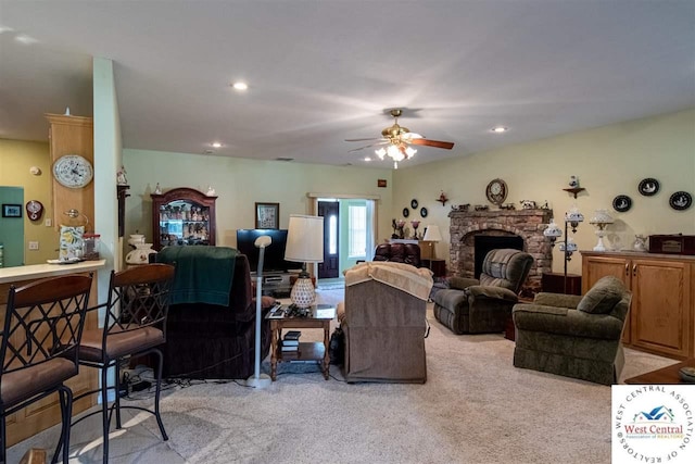 living room featuring recessed lighting, ceiling fan, light carpet, and a fireplace