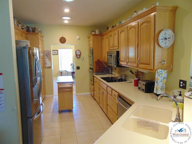 kitchen featuring recessed lighting, light tile patterned floors, appliances with stainless steel finishes, light countertops, and a sink