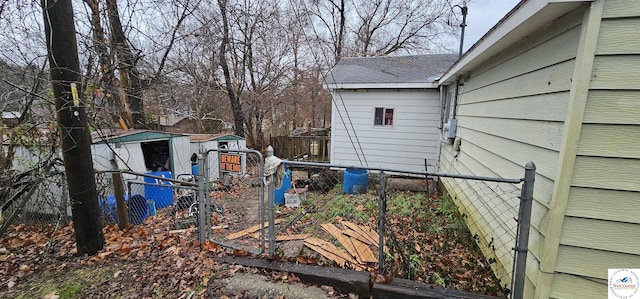 31591 Spring Ave, Warsaw, MO 65355 - view of side of property featuring an outbuilding, a shed, and a fenced backyard