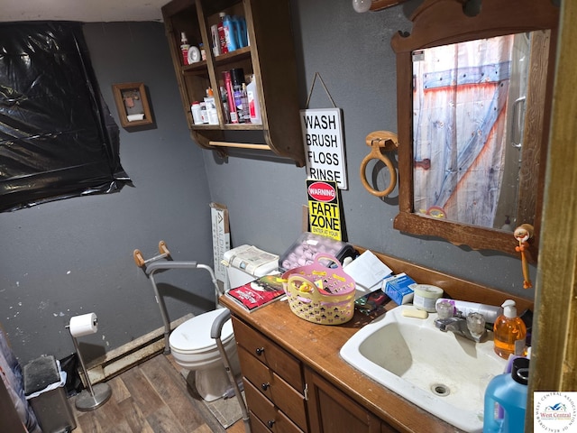 31591 Spring Ave, Warsaw, MO 65355 - half bath featuring toilet, vanity, wood finished floors, and baseboards