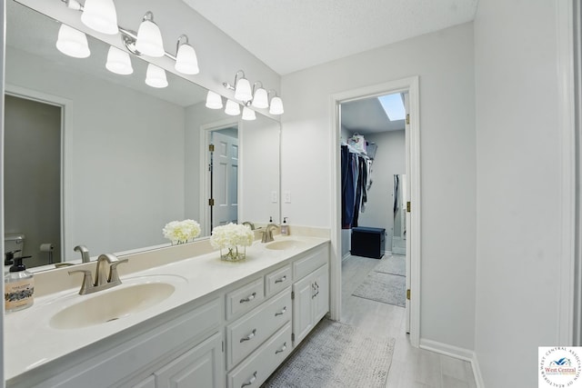 1515 NW Primrose Ln, Blue Springs, MO 64015 - full bathroom featuring double vanity, toilet, baseboards, and a walk in closet