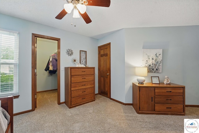 1515 NW Primrose Ln, Blue Springs, MO 64015 - bedroom featuring a spacious closet, light carpet, baseboards, a closet, and a ceiling fan