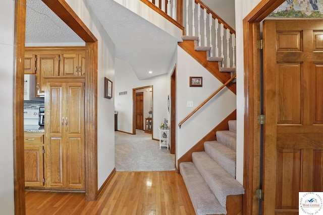 1515 NW Primrose Ln, Blue Springs, MO 64015 - foyer entrance with light wood-type flooring, stairs, baseboards, and recessed lighting