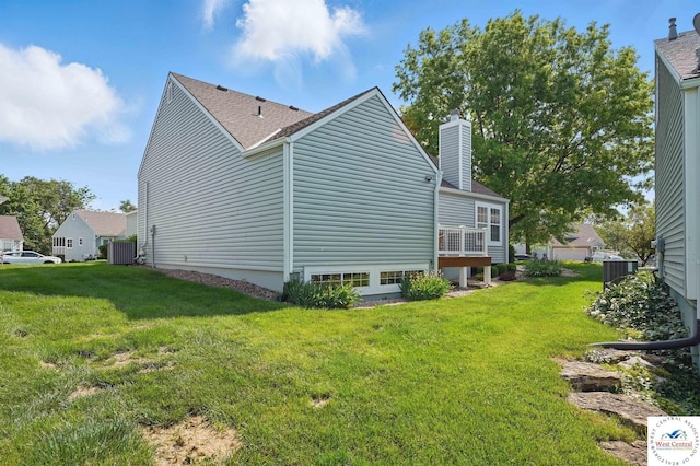 1515 NW Primrose Ln, Blue Springs, MO 64015 - view of side of home featuring cooling unit, a chimney, and a lawn