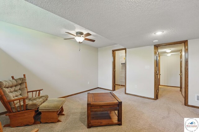 1515 NW Primrose Ln, Blue Springs, MO 64015 - living area featuring a ceiling fan, baseboards, carpet flooring, and a textured ceiling