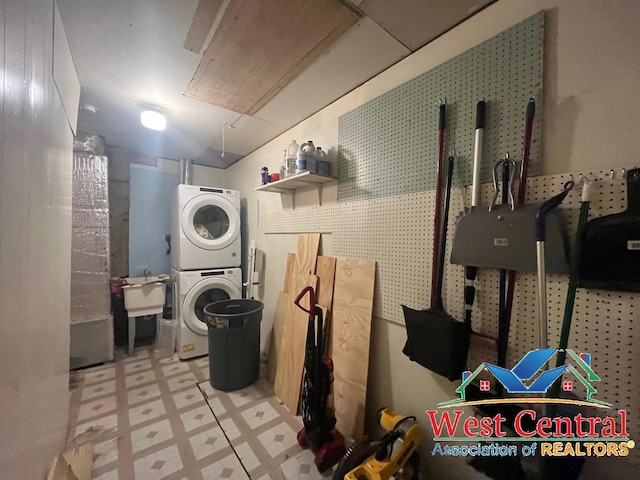 104 E Main St, Cole Camp, MO 65325 - washroom featuring tile patterned floors, stacked washer and clothes dryer, laundry area, and a sink