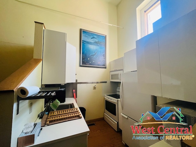 104 E Main St, Cole Camp, MO 65325 - kitchen featuring dark wood-style floors, a sink, light countertops, and white appliances