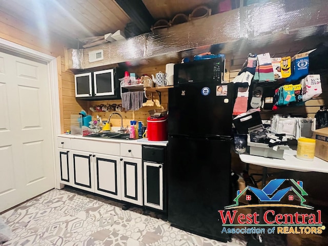 104 E Main St, Cole Camp, MO 65325 - kitchen featuring open shelves, light countertops, freestanding refrigerator, and a sink