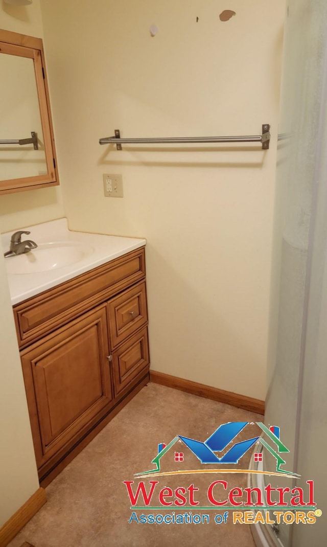 104 E Main St, Cole Camp, MO 65325 - bathroom featuring baseboards and vanity