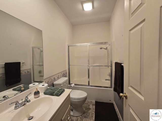 1017 E Trevino Rd, Clinton, MO 64735 - bathroom featuring bath / shower combo with glass door, toilet, and vanity