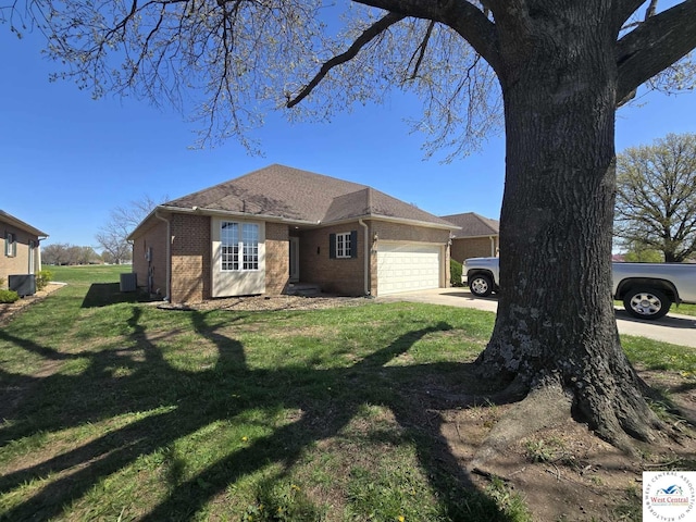 1017 E Trevino Rd, Clinton, MO 64735 - view of property exterior with driveway, a yard, a garage, and brick siding