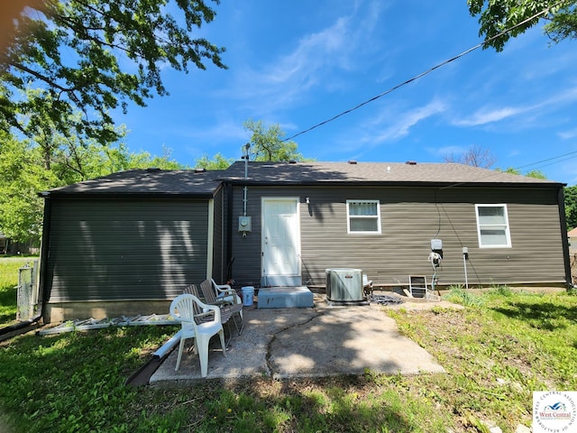 rear view of property with a patio area, a yard, and cooling unit
