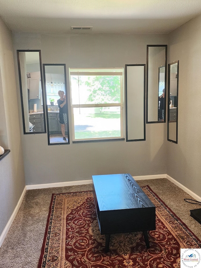 recreation room with carpet flooring and baseboards