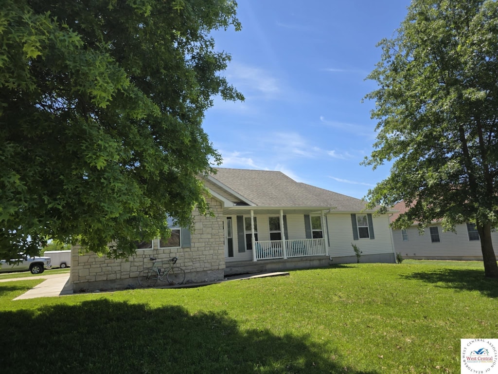 200 W Allison Ln, Clinton, MO 64735 - ranch-style house featuring a porch, a front lawn, stone siding, and a shingled roof