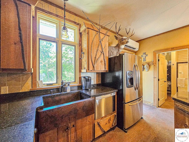 kitchen featuring stainless steel appliances, backsplash, hanging light fixtures, and a sink
