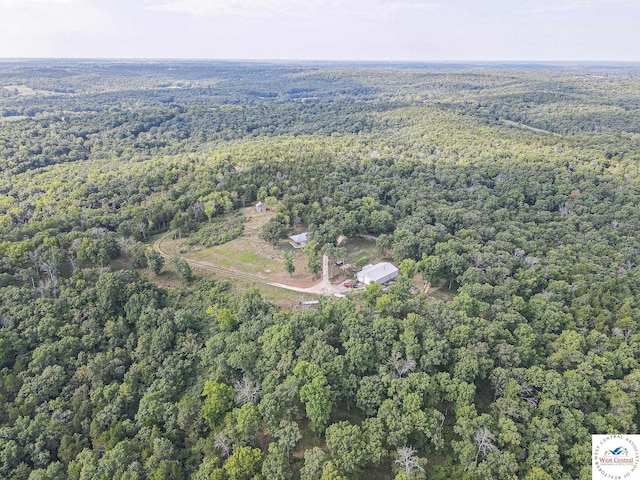 birds eye view of property with a wooded view