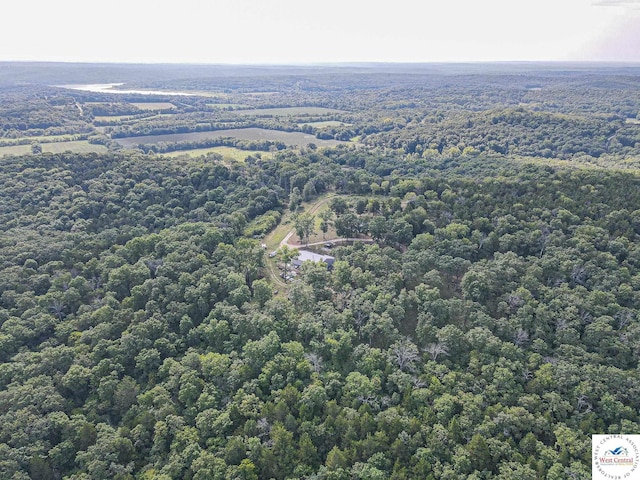 birds eye view of property with a view of trees