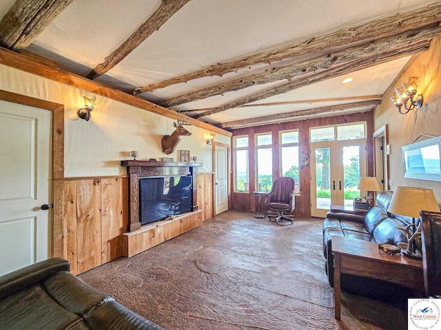 living area with wood walls, french doors, beamed ceiling, and wainscoting