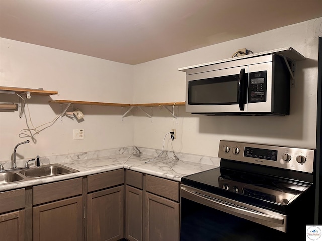 23651 Pifer St, Warsaw, MO 65355 - kitchen featuring stainless steel range with electric stovetop, a sink, open shelves, and light countertops
