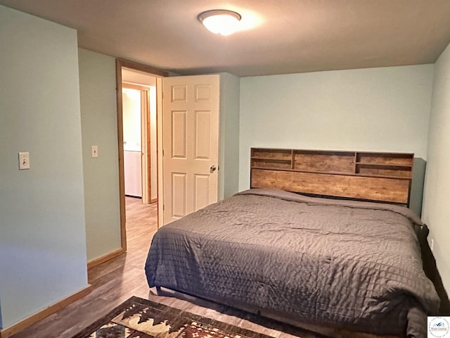 23651 Pifer St, Warsaw, MO 65355 - bedroom featuring wood finished floors and baseboards