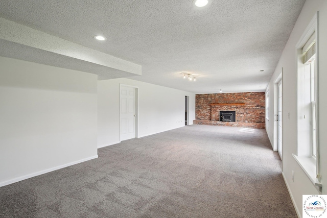 29950 Binder Rd, Green Ridge, MO 65332 - unfurnished living room featuring carpet flooring, a brick fireplace, a textured ceiling, baseboards, and recessed lighting
